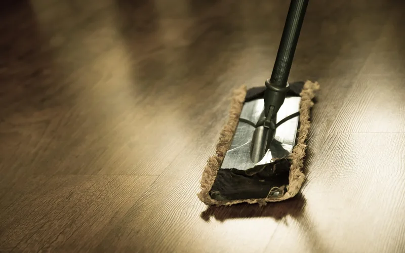 Microfiber mop head gliding across an engineered wood floor
