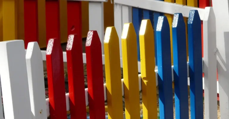 painted wooden picket fence in red, yellow, blue and white