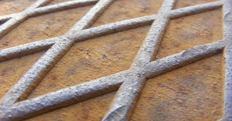 Rusted steel diamond plate showing orange surface rust