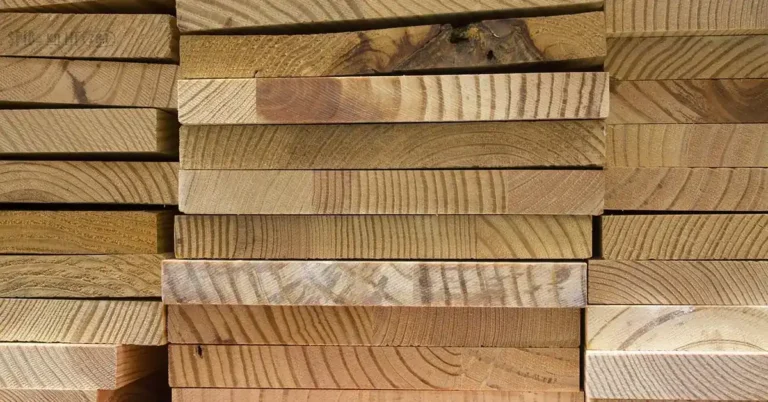 pile of stacked scrap lumber and wood boards ready for disposal or recycling drop-off