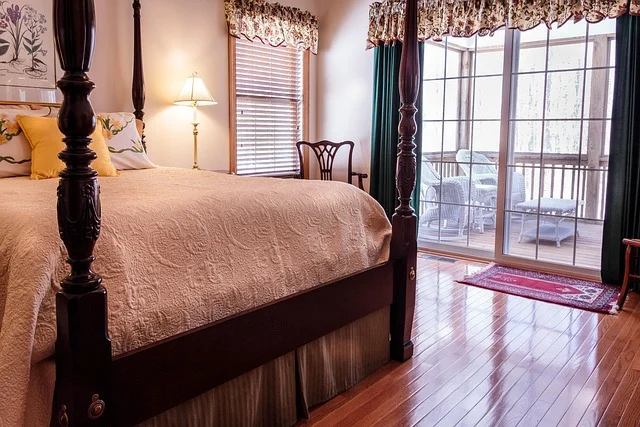 Sliding glass patio door in a bedroom with hardwood flooring
