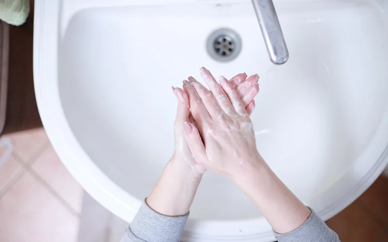 washing hands with warm soapy water to loosen dried super glue
