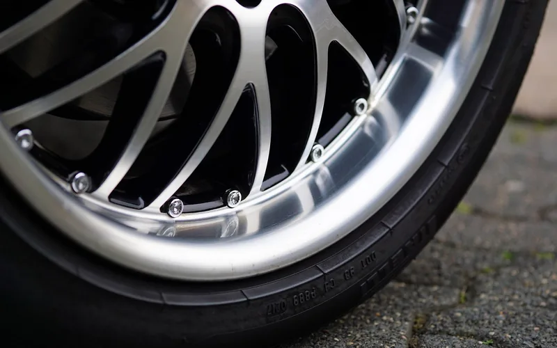 close-up of a polished aluminum alloy wheel rim showing a mirror-like shine