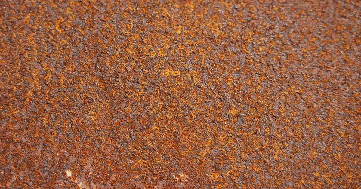 Close-up of a bare rusty metal surface before cleaning and priming