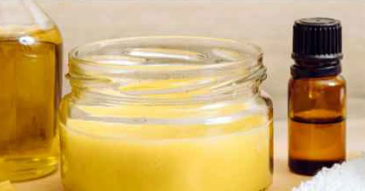jar of beeswax and mineral oil board butter next to mineral oil bottle