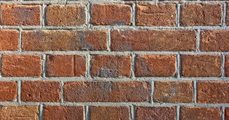 close-up of a red brick wall showing mortar joints between bricks
