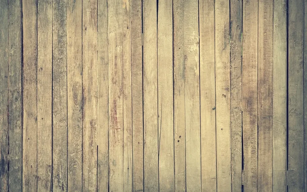 Pale weathered vertical wood planks forming a rustic paneled wall surface