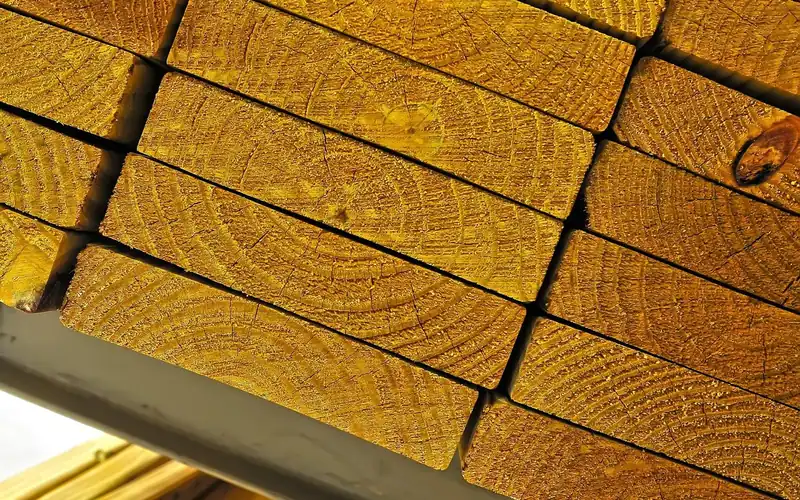 stacked dimensional lumber showing beam cross-section end grain stacked dimensional lumber showing beam cross-section end grain