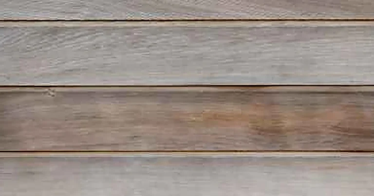 Weathered gray Douglas fir wood planks showing untreated outdoor wear