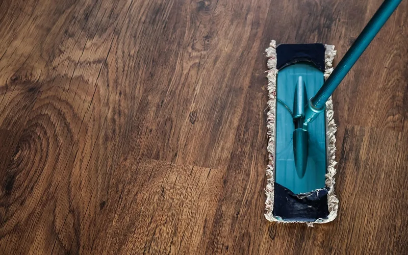 Flat microfiber dust mop head resting on a hardwood floor