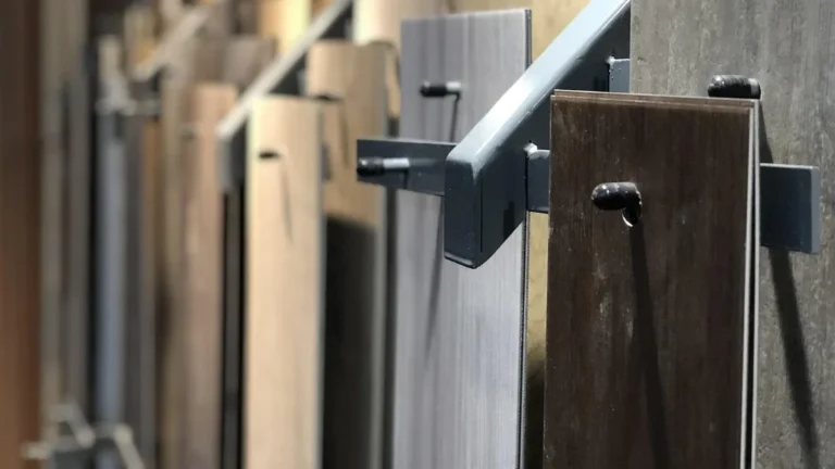 Rack of wood-look flooring plank samples in a flooring showroom