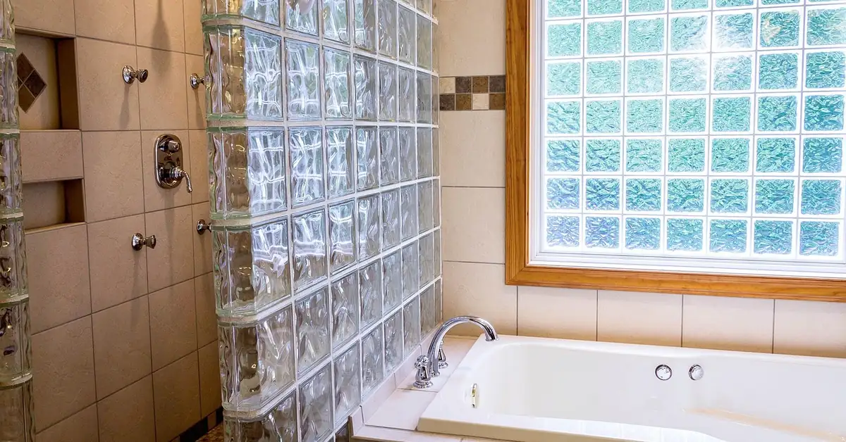 glass block window installed in a bathroom wall, providing privacy and natural light