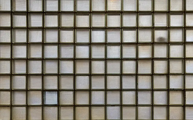 close-up of clear glass blocks assembled into a wall, showing the block size and texture