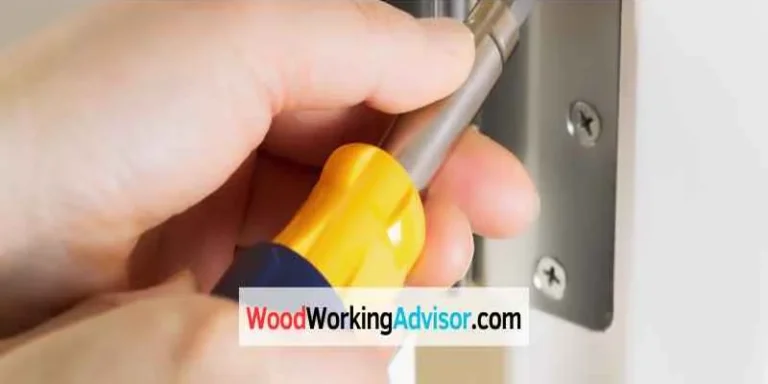 Adjusting a door hinge with a screwdriver