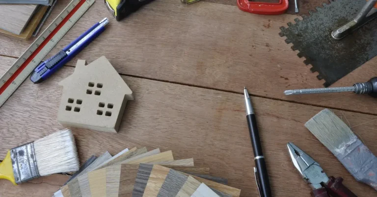 Laminate flooring plank samples and repair tools laid out for a warped floor project