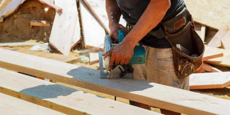 Handheld circular saw cutting a wood board