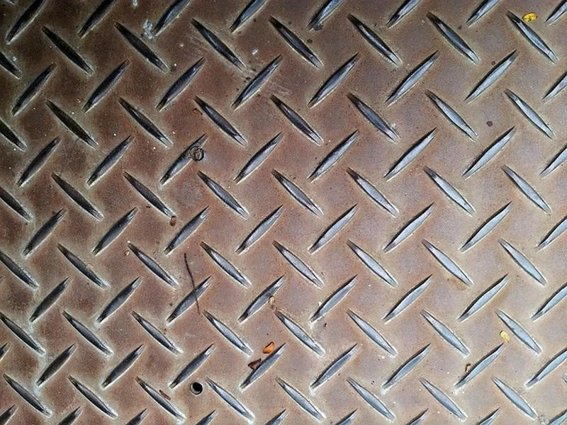 Rusty steel panel that needs sanding and cleaning before priming and paint