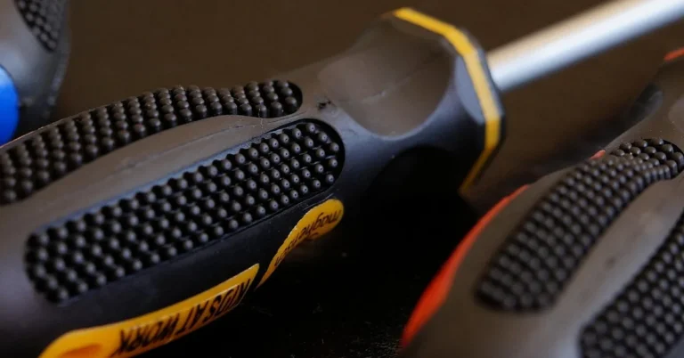 assorted screwdrivers with ergonomic grips laid out closeup