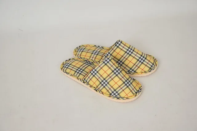A pair of soft-soled slippers resting on a wood floor A pair of soft-soled slippers resting on a wood floor