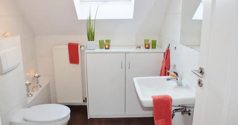 Bathroom toilet on finished dark wood-look vinyl plank flooring