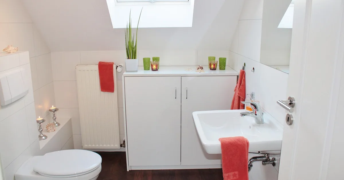 Bathroom toilet on finished dark wood-look vinyl plank flooring