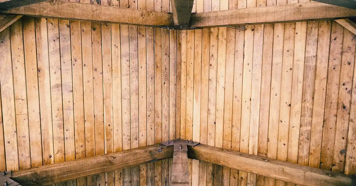 exposed wood ceiling beams supporting a roof structure