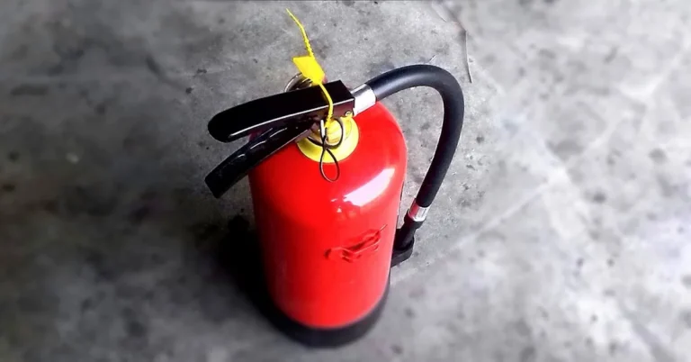 red fire extinguisher on a garage workshop floor