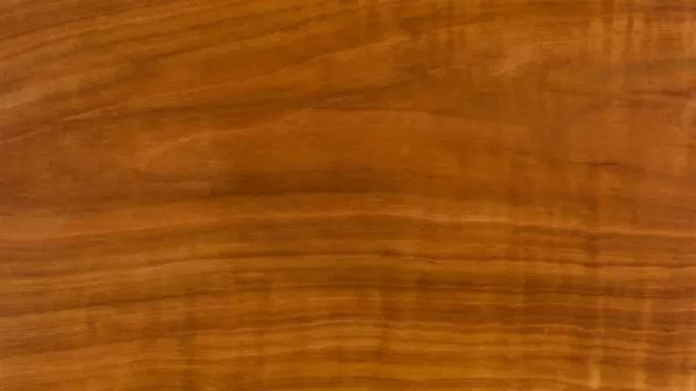 Close-up of cherry wood grain showing its warm reddish-brown color and fine straight grain