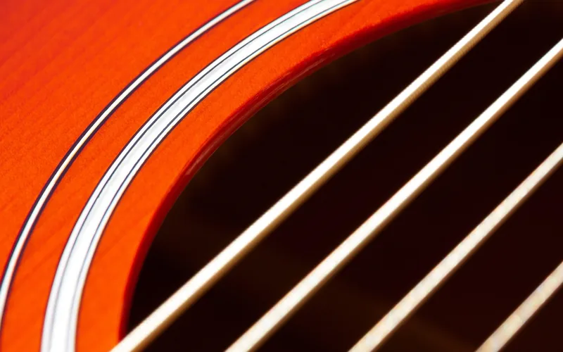 Close-up of an acoustic guitar soundhole with strings