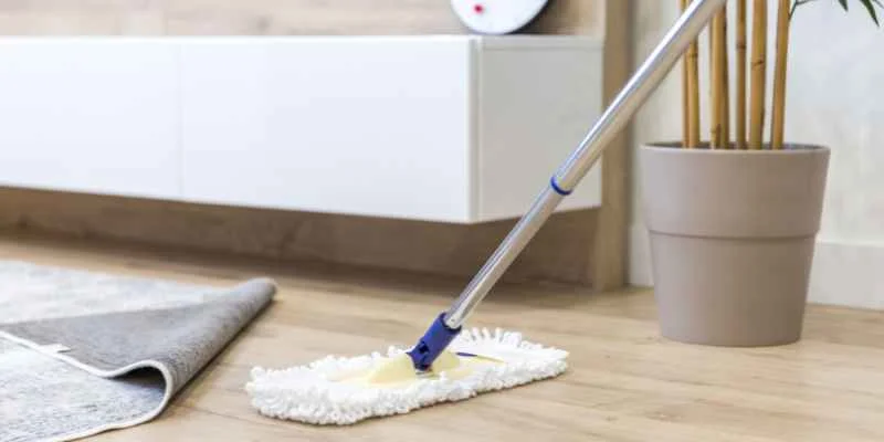 Mopping a wood floor with a flat microfiber mop