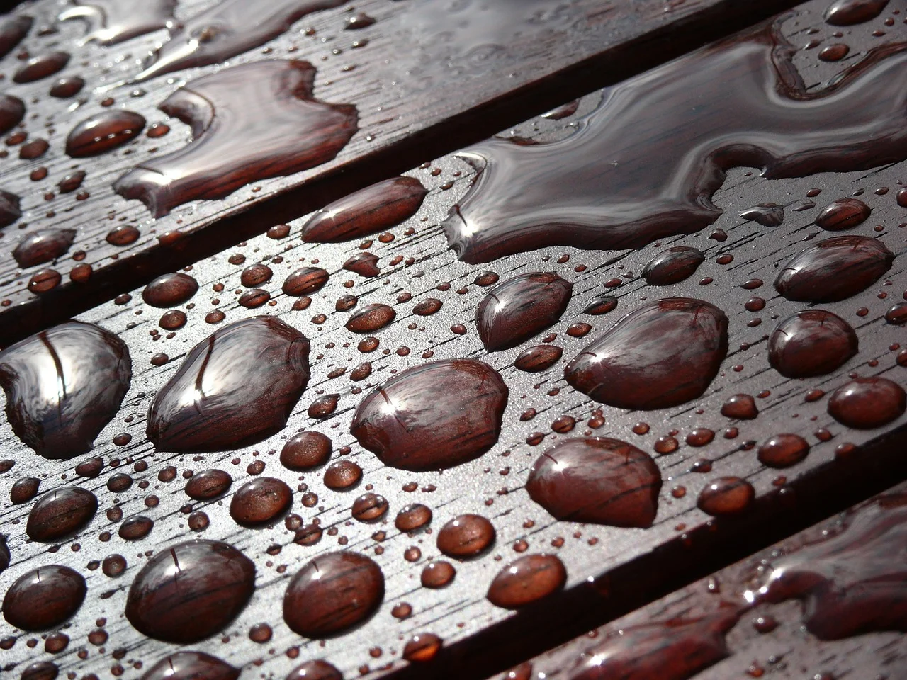 Water beading up on a properly waterproofed wood table surface