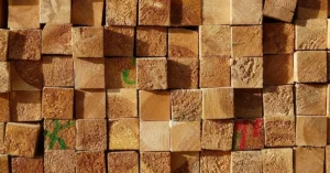 End grain of stacked dimensional lumber boards in a lumber yard