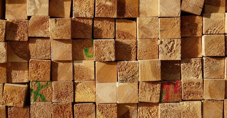 End grain of stacked dimensional lumber boards in a lumber yard