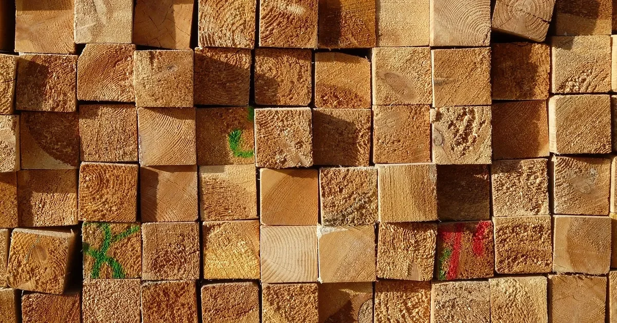 End grain of stacked dimensional lumber boards in a lumber yard