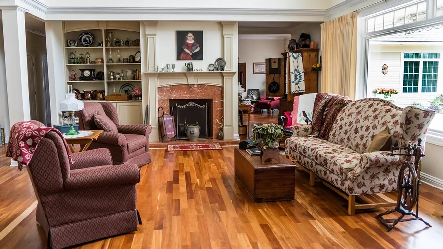 Area rug on a hardwood floor in a living room with wood furniture Area rug on a hardwood floor in a living room with wood furniture