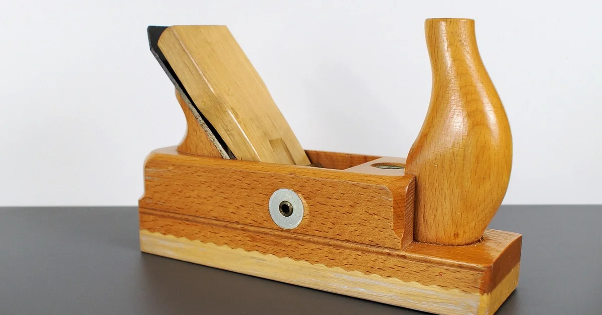 Wooden hand plane used for smoothing ash wood in woodworking