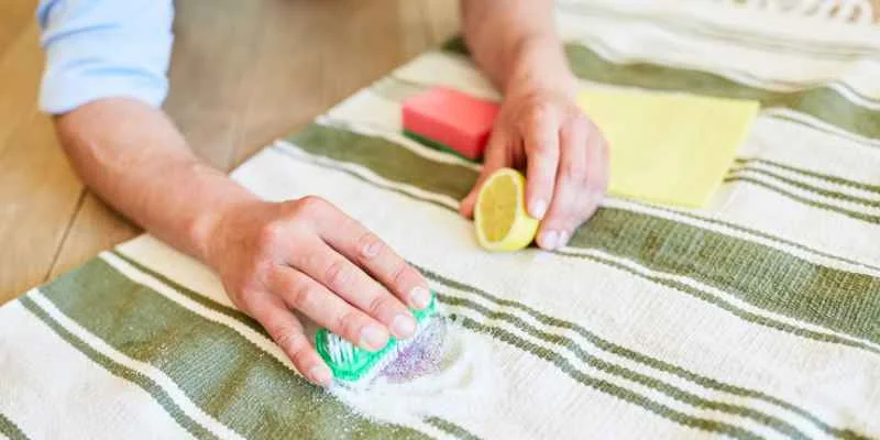 Cleaning a stained area rug with a sponge