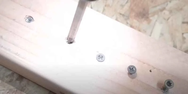 Drilling into a headless screw to prepare for extraction