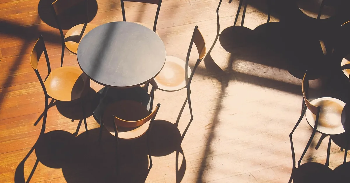 Round dining chairs and table on a sunlit hardwood floor