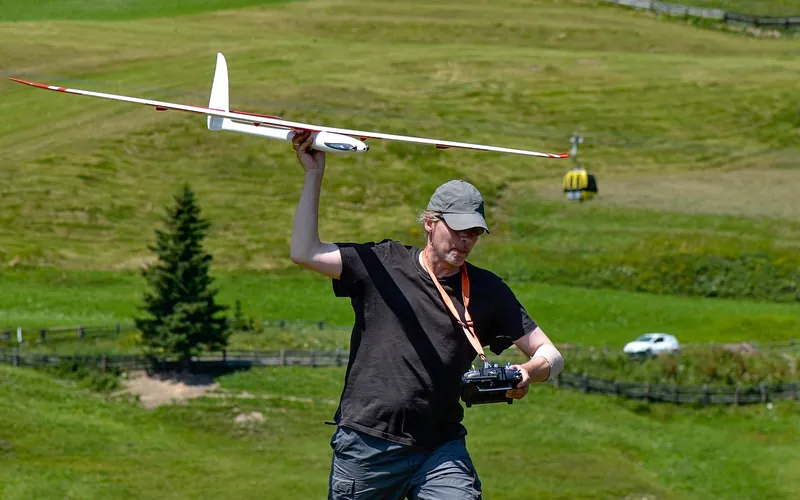 Hobbyist hand-launching a lightweight model glider Hobbyist hand-launching a lightweight model glider