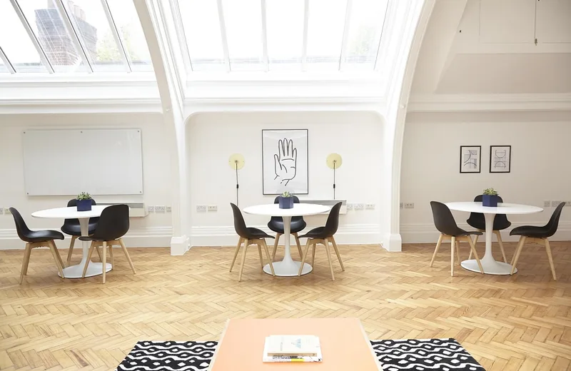 Dining chairs with wooden legs on a herringbone hardwood floor