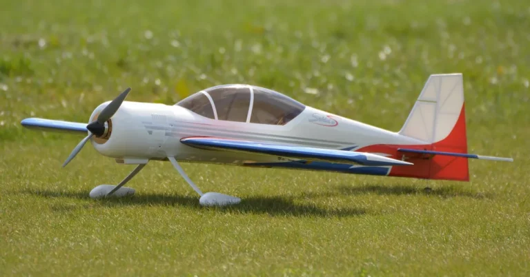 Model airplane resting on a grass airfield