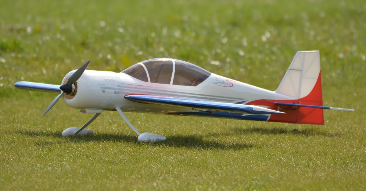 Model airplane resting on a grass airfield