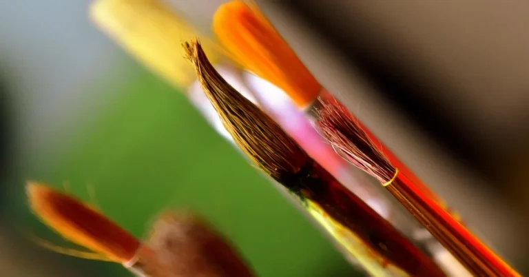 paintbrush bristles caked with dried acrylic paint at the ferrule, close up