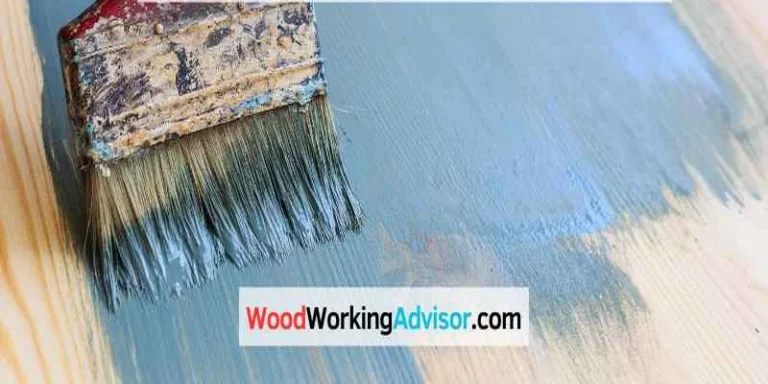 Painting a wood board with blue paint using a paintbrush