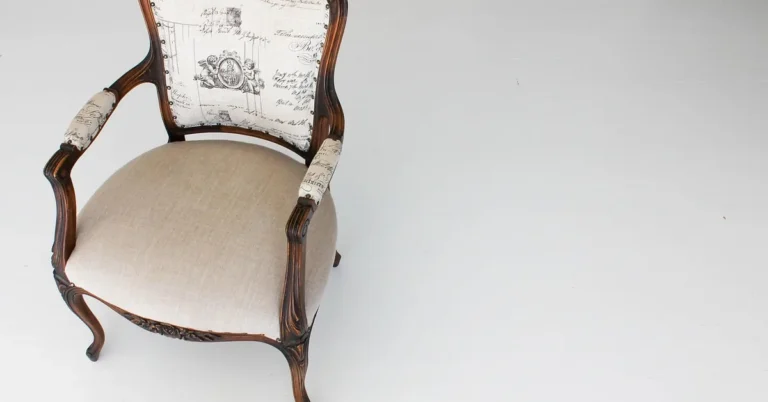 Antique wood armchair with a hand-carved frame showing a built-up paste wax finish