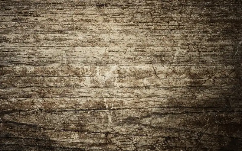 Stack of pine and oak lumber boards showing grain differences used for door casing material selection