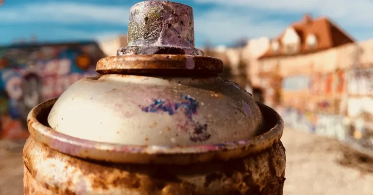 close-up of an aerosol spray paint can nozzle and rim