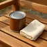 Can of teak oil wood finish with an application cloth