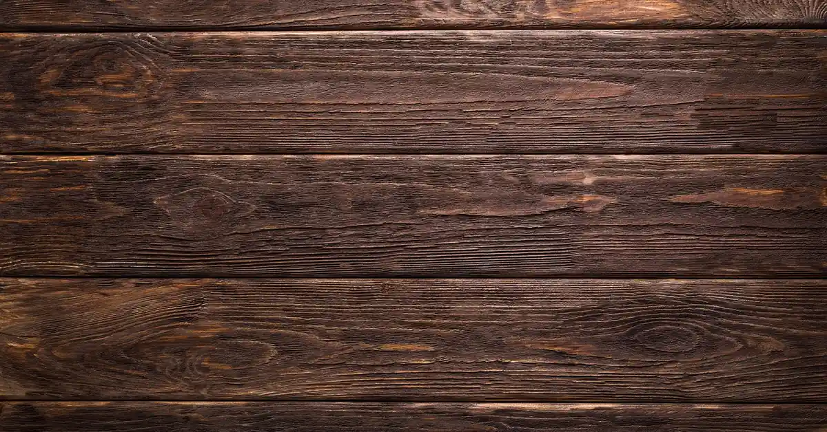 Dark brown thermally modified wood decking boards laid side by side